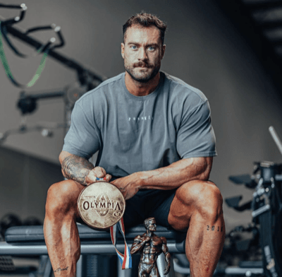 Chris Bumstead holding the Mr. Olympia medal
